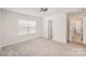 Comfortable bedroom with plush carpet, a ceiling fan, a window, and an entrance to another room at 2039 Morning Gold Dr, Maiden, NC 28650