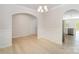 Open dining room with hardwood floors, modern lighting, and archway to kitchen at 2039 Morning Gold Dr, Maiden, NC 28650
