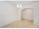 Bright dining room featuring hardwood floors, an archway, and modern chandelier at 2039 Morning Gold Dr, Maiden, NC 28650
