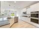Open-concept kitchen featuring white cabinets, stainless steel appliances, granite countertops, and modern pendant lights at 2039 Morning Gold Dr, Maiden, NC 28650