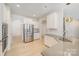 Bright kitchen with stainless steel appliances, white cabinetry, granite countertops, and hardwood floors at 2039 Morning Gold Dr, Maiden, NC 28650