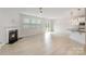 Open concept living room with hardwood floors, a fireplace, and an open kitchen at 2039 Morning Gold Dr, Maiden, NC 28650