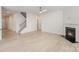 Spacious living room featuring hardwood floors, stairs, and fireplace at 2039 Morning Gold Dr, Maiden, NC 28650