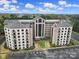 Aerial view of condo complex featuring a tower and balcony views, surrounded by parking at 211 Heritage Blvd # 301, Fort Mill, SC 29715