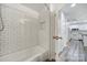 Bathroom featuring subway tile shower and an adjacent kitchen view through doorway at 211 Heritage Blvd # 301, Fort Mill, SC 29715