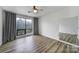 Well-lit bedroom featuring wood-look floors, a large window with curtains, and ample natural light at 211 Heritage Blvd # 301, Fort Mill, SC 29715