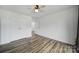 Bright bedroom with wood-look floors, a ceiling fan, double closets, and a doorway to another room at 211 Heritage Blvd # 301, Fort Mill, SC 29715