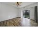 Well-lit bedroom with wood-look floors and a sliding glass door leading to a balcony at 211 Heritage Blvd # 301, Fort Mill, SC 29715