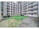 Exterior view of condo complex with courtyard with lawn, walkways, and benches at 211 Heritage Blvd # 301, Fort Mill, SC 29715