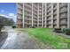 Exterior view of the condo complex shows a courtyard with trees, lawn, and walkways at 211 Heritage Blvd # 301, Fort Mill, SC 29715