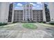Exterior view of condo complex featuring a central tower and landscaped walkway at 211 Heritage Blvd # 301, Fort Mill, SC 29715
