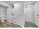Hallway with wood-look floors, a laundry closet, and a doorway to a bathroom with white subway tile at 211 Heritage Blvd # 301, Fort Mill, SC 29715