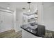 Bright kitchen featuring white cabinets, modern appliances, a black countertop, and wood-look flooring at 211 Heritage Blvd # 301, Fort Mill, SC 29715
