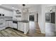 Modern kitchen with white cabinets, black countertops, and subway tile backsplash, flowing into a living area with outdoor access at 211 Heritage Blvd # 301, Fort Mill, SC 29715