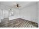 Bright and spacious living room with hardwood floors, a ceiling fan, and an open doorway to an adjacent room at 211 Heritage Blvd # 301, Fort Mill, SC 29715