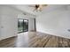 Bright and airy living room with hardwood floors, a ceiling fan, and sliding glass doors to a private balcony at 211 Heritage Blvd # 301, Fort Mill, SC 29715
