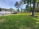 Spacious backyard with a deck, a new wooden fence, and mature trees, perfect for outdoor enjoyment at 166 Brook Creek Dr, Troutman, NC 28166