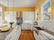Modern kitchen with white cabinetry, stainless steel appliances, large island and hardwood floors at 2009 Waterbury Ln, Waxhaw, NC 28173