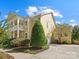 Side view of a two-story home with a spacious driveway and well-maintained landscaping at 2009 Waterbury Ln, Waxhaw, NC 28173