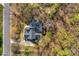 An aerial view of a home surrounded by trees and a driveway leading to the street at 3109 Savannah Hills Dr, Matthews, NC 28105