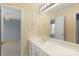 Charming bathroom with a large mirror, white vanity, and classic patterned wallpaper at 3109 Savannah Hills Dr, Matthews, NC 28105