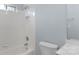 Bathroom with white tiled shower-tub combination, white toilet, and blue walls for a clean and simple design at 3109 Savannah Hills Dr, Matthews, NC 28105