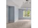 An empty bedroom with a ceiling fan and large window allowing natural light at 3109 Savannah Hills Dr, Matthews, NC 28105