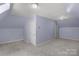 A spacious bonus room with neutral carpet, two lights, and a simple closet at 3109 Savannah Hills Dr, Matthews, NC 28105