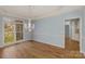 Dining room featuring hardwood floors, a decorative chandelier, and a large window offering ample natural light at 3109 Savannah Hills Dr, Matthews, NC 28105