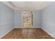 Dining room featuring hardwood floors, a decorative chandelier, and a large window offering ample natural light at 3109 Savannah Hills Dr, Matthews, NC 28105