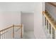 Upstairs hallway with wooden railings overlooking a staircase, offering an airy and bright transition space at 3109 Savannah Hills Dr, Matthews, NC 28105
