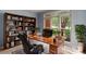 Bright home office with built-in bookshelves, large window, and stylish decor provides a functional workspace at 3109 Savannah Hills Dr, Matthews, NC 28105