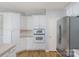 Kitchen showcasing white cabinets, stainless steel appliances, and hardwood floors at 3109 Savannah Hills Dr, Matthews, NC 28105