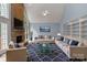 Spacious living room featuring a stone fireplace, vaulted ceiling, and three couches at 3109 Savannah Hills Dr, Matthews, NC 28105