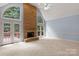 Bright living room showcases a stone fireplace, vaulted ceiling, and access to the outdoors at 3109 Savannah Hills Dr, Matthews, NC 28105