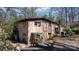 Back exterior of brick home features a greenhouse, patio, and lush landscaping at 3407 14Th Sw Ave, Hickory, NC 28602