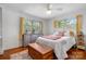 Bedroom featuring two windows, a ceiling fan, and a cozy bed with decorative pillows at 3407 14Th Sw Ave, Hickory, NC 28602
