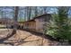 Brick home features a covered front porch with seating, lush yard, and shade trees at 3407 14Th Sw Ave, Hickory, NC 28602