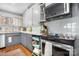 Efficient kitchen layout featuring stainless steel appliances, white cabinetry, and gray lower cabinets at 3407 14Th Sw Ave, Hickory, NC 28602