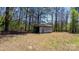Storage shed with sliding doors nestled among trees at 3407 14Th Sw Ave, Hickory, NC 28602