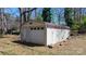Storage shed features a metal roof and large garage door with yard at 3407 14Th Sw Ave, Hickory, NC 28602