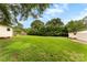 Large grassy backyard with multiple storage buildings and mature trees at 4107 Windwood Dr, Gastonia, NC 28056