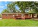 A large brick home with a great backyard space, including a wooden deck at 4107 Windwood Dr, Gastonia, NC 28056