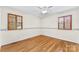Bedroom featuring hardwood floors, two windows, and ceiling fan at 4107 Windwood Dr, Gastonia, NC 28056