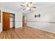 Spacious bedroom with hardwood floors, ceiling fan, closet and ensuite access at 4107 Windwood Dr, Gastonia, NC 28056