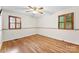 Bright bedroom features hardwood floors, two windows and ceiling fan at 4107 Windwood Dr, Gastonia, NC 28056