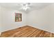 Cozy bedroom with natural light, hardwood floors, ceiling fan and wooden window shutters at 4107 Windwood Dr, Gastonia, NC 28056