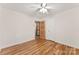 Bedroom with hardwood floors, neutral walls, ceiling fan, closet, and ensuite access at 4107 Windwood Dr, Gastonia, NC 28056
