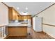 Open kitchen layout with dark wood-look floors and natural wood cabinetry at 4107 Windwood Dr, Gastonia, NC 28056