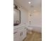 Clean bathroom with a shower-tub combo, a white vanity with dark accents, and plank flooring at 4969 Fitzgerald Ave, Charlotte, NC 28213